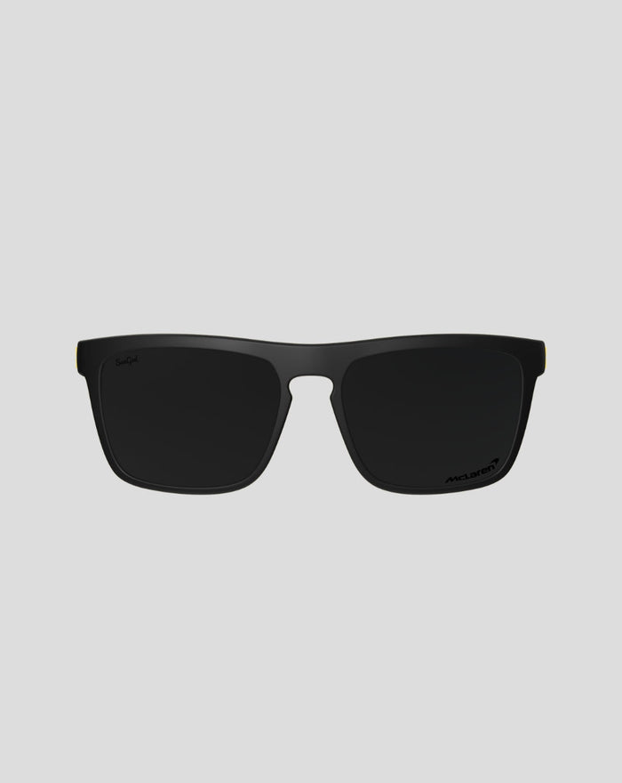 Front view of McLaren SunGod Renegades sunglasses with black frame dark lenses and a yellow accent at the temple