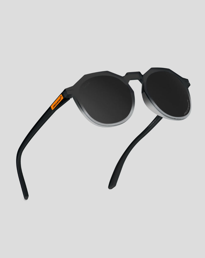 SunGod x McLaren Core Zephyrs sunglasses side view with black round lenses silver rims and orange temple badge