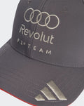 Front close-up of grey cap with embroidered Audi rings and Revolut F1 Team text with metallic brim detail