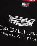 Close up of neck label with Tommy Hilfiger flag and Cadillac Formula 1 Team graphic on black varsity jacket