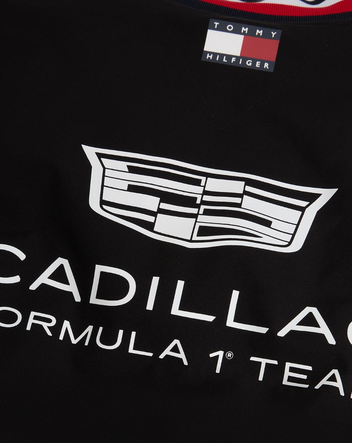 Close up of neck label with Tommy Hilfiger flag and Cadillac Formula 1 Team graphic on black varsity jacket