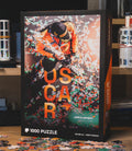 McLaren Formula 1 Oscar Piastri 1000 piece puzzle box art showing a driver in an orange suit amid confetti