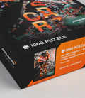 Angled close-up of the McLaren Oscar Piastri puzzle box with confetti and bold orange lettering