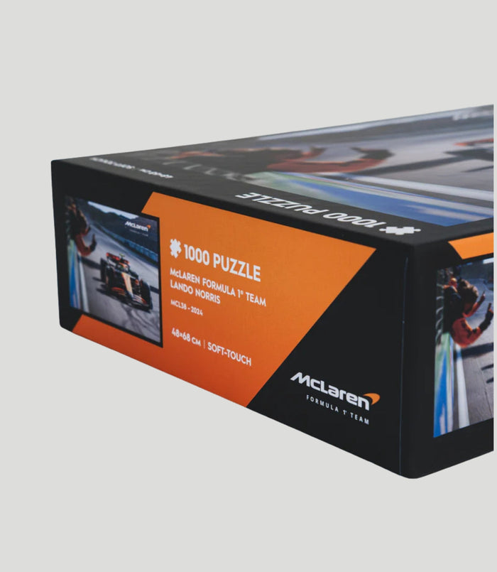 Angled McLaren Formula 1 Team 1000 piece puzzle box showing Lando Norris with orange side panel