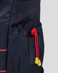 Side pocket with red drawcord and yellow toggles on a navy backpack