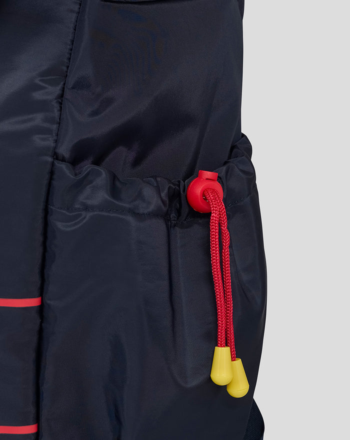 Side pocket with red drawcord and yellow toggles on a navy backpack