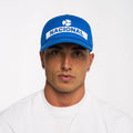 Blue Nacional replica cap on model with bold white Nacional logo on front and Senna signature on the side