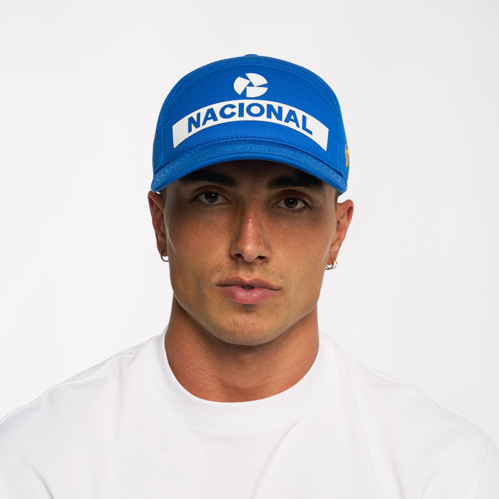 Blue Nacional replica cap on model with bold white Nacional logo on front and Senna signature on the side