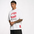 Male model wearing white Ayrton Senna oversized graphic T shirt with a red curved logo on chest