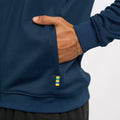 Detail of navy jacket hem showing multicolor stripe tab