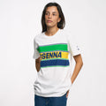 Model wearing white Ayrton Senna Retro Stripe T shirt with green blue yellow stripes across chest and SENNA lettering