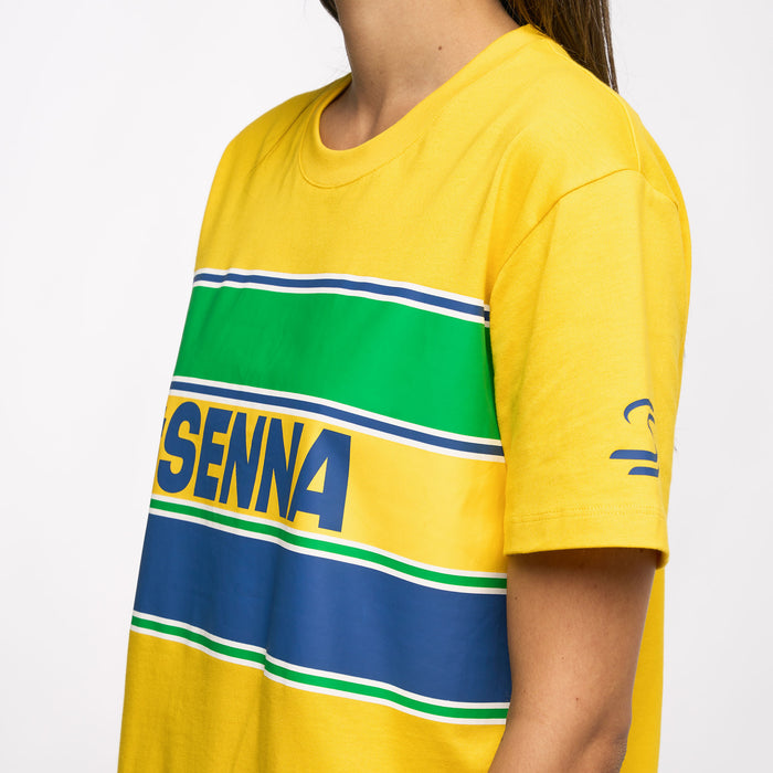 Close up of yellow Ayrton Senna Retro Stripe T Shirt showing a green white blue stripe across the chest and a side Senna stripe tab