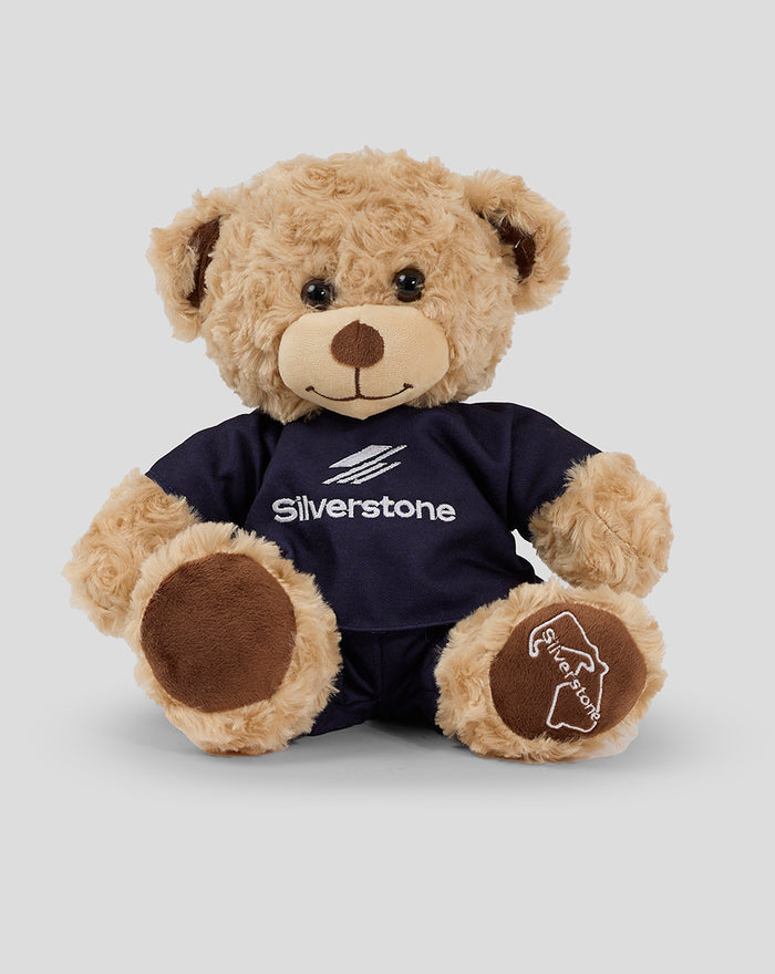 Soft tan 10 inch Charlie Bear plush wearing a navy Silverstone shirt facing forward