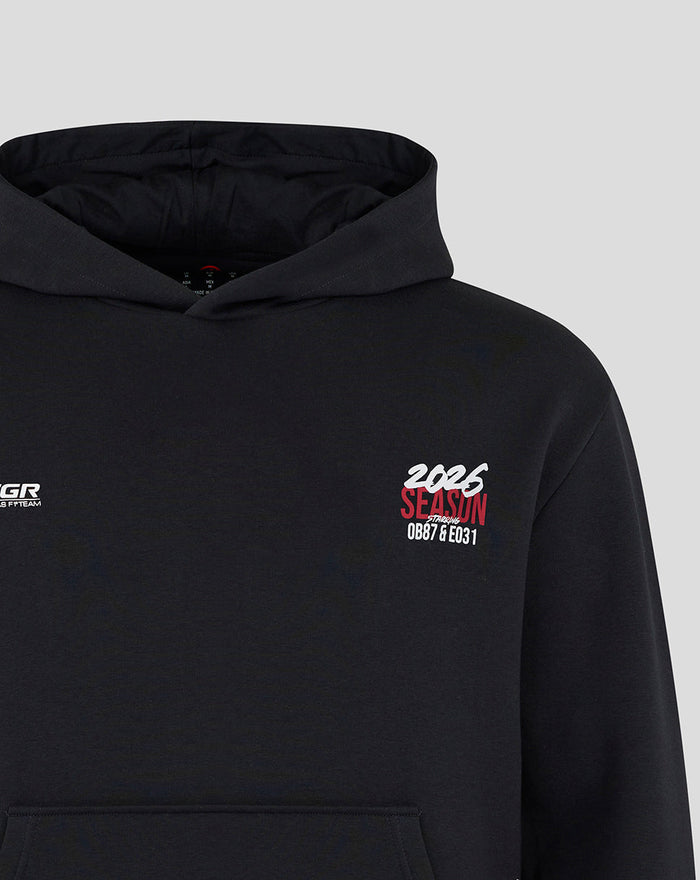 Close up front showing left chest TGR Haas F1 Team logo and right chest red 2026 season graphic on black hoodie