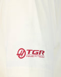 Close-up of an Egret white T-shirt sleeve showing the Haas F1 Team TGR logo in red