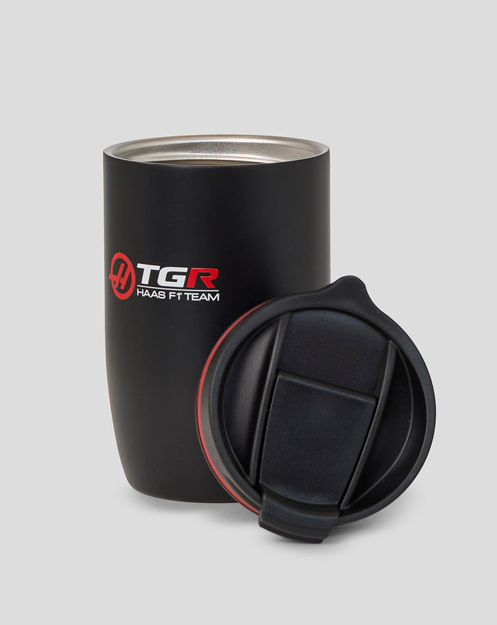 Haas F1 Team travel cup with black body red ring and lid beside