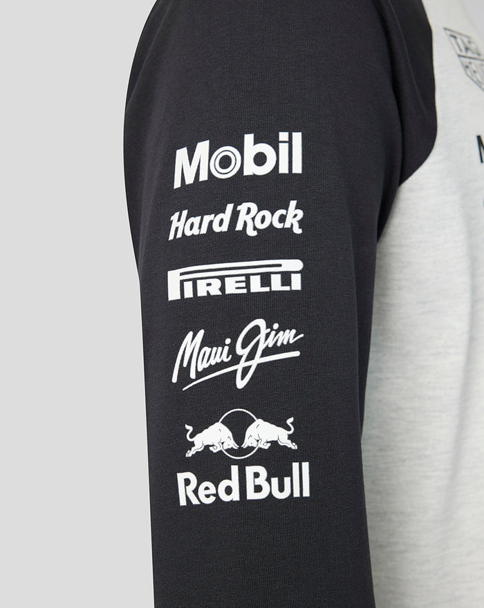 Black sleeve of a Raglan shirt featuring white sponsor logos Mobil Hard Rock Pirelli Maui Jim and Red Bull