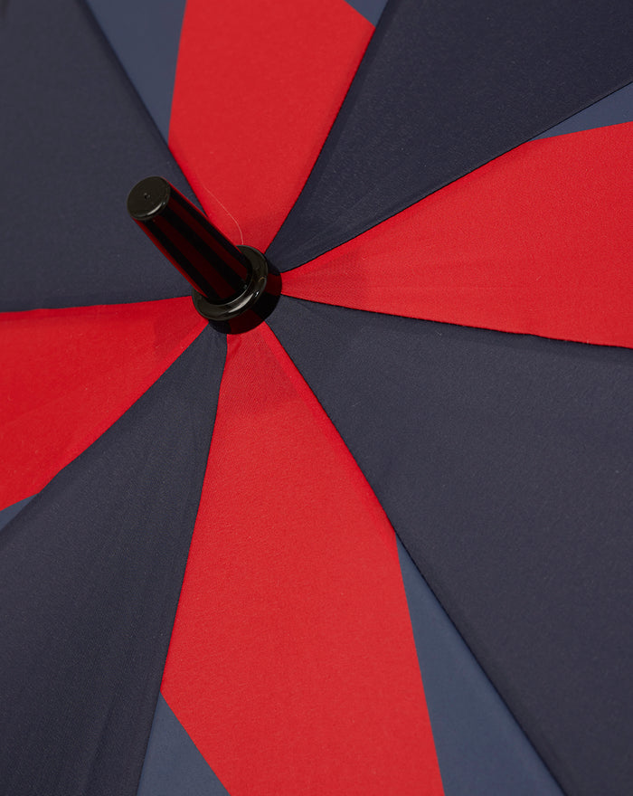 Open Silverstone umbrella with navy and red color block panels and a black hub