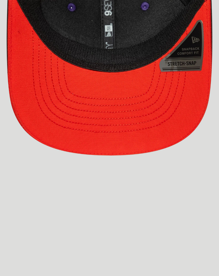 Close up of the curved brim with red underside and the 72 patch on a black Aprilia Racing cap