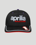 Front view of black 9SEVENTY cap with white aprilia racing logo and red RACING lettering, purple eyelets, and red undervisor.