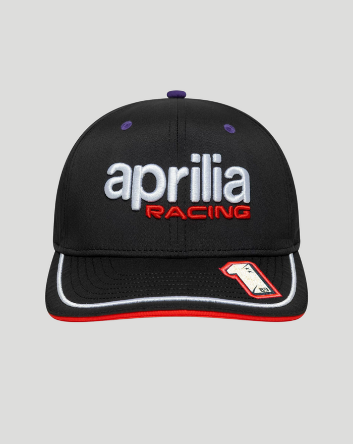 Front view of black 9SEVENTY cap with white aprilia racing logo and red RACING lettering, purple eyelets, and red undervisor.