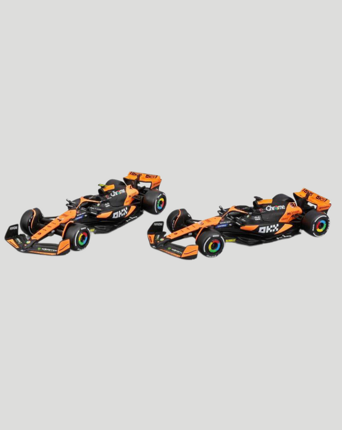 Two orange and black 1:43 McLaren MCL38 Piastri model cars shown side by side