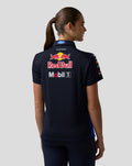 Back view of a woman wearing a navy Oracle Red Bull Racing team polo with large Red Bull and Mobil 1 logos