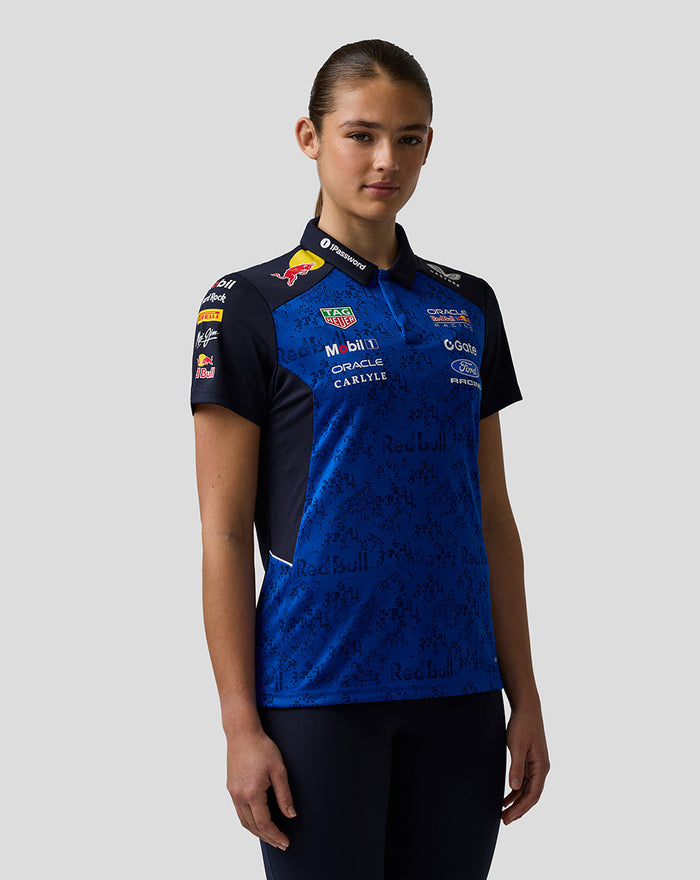 Female model wearing Oracle Red Bull Racing Teamline Polo in blue with sponsor logos across the chest