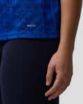 Close-up of blue fabric from the Oracle Red Bull Racing polo showing AerTek branding and pixel pattern
