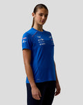 Woman models a blue BWT Alpine Set Up T Shirt with team logos on the chest and pink shoulder piping.