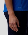 Blue BWT Alpine Set Up T Shirt close up of hem showing AerTek label on textured fabric.