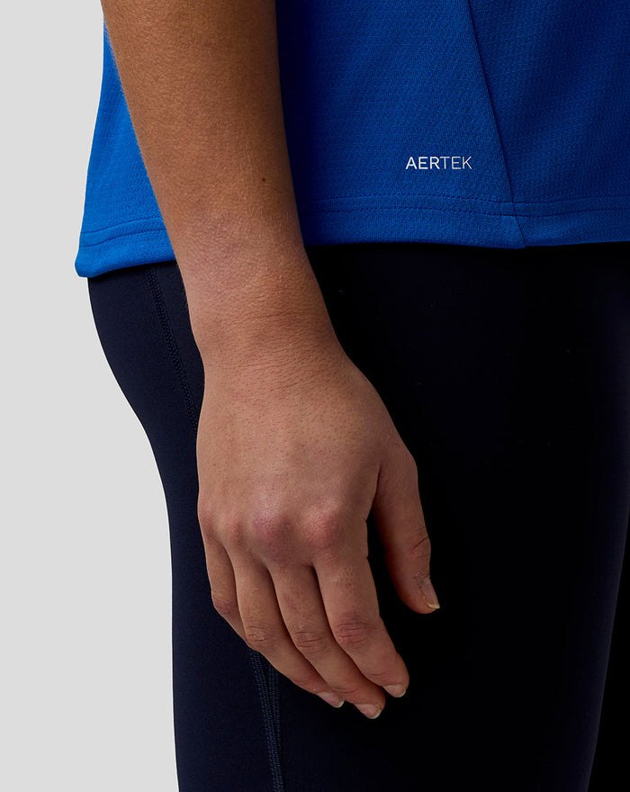 Blue BWT Alpine Set Up T Shirt close up of hem showing AerTek label on textured fabric.