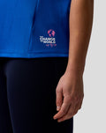 Detail of blue BWT Alpine Set Up T Shirt with Change the World logo near the hem on the side.