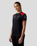 Haas Team women's driver T shirt worn by model with red shoulder panels and USA flag on sleeve featuring AerTek moisture-wicking fabric