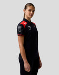 Three quarter view of a female model in Haas Team polo showing red shoulder panels and patterned sleeve cuffs
