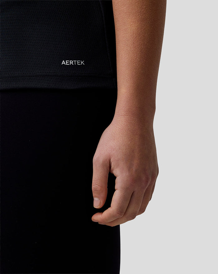 Close-up of the Haas Team polo sleeve showing AerTek branding on black fabric