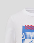 Front close up of white T shirt showing a blue square graphic with red diagonal stripes and white waves.