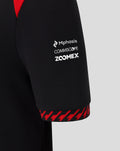 Close up of black Haas junior driver T-shirt sleeve with Mphasis COMMSCOPE ZOOMEX logos and a red patterned cuff