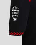 Close up of black Haas team junior driver T-shirt sleeve with RUCKUS NETWORKS PIRELLI UChicago Medicine infobip and FIX NETWORK logos and a red patterned cuff