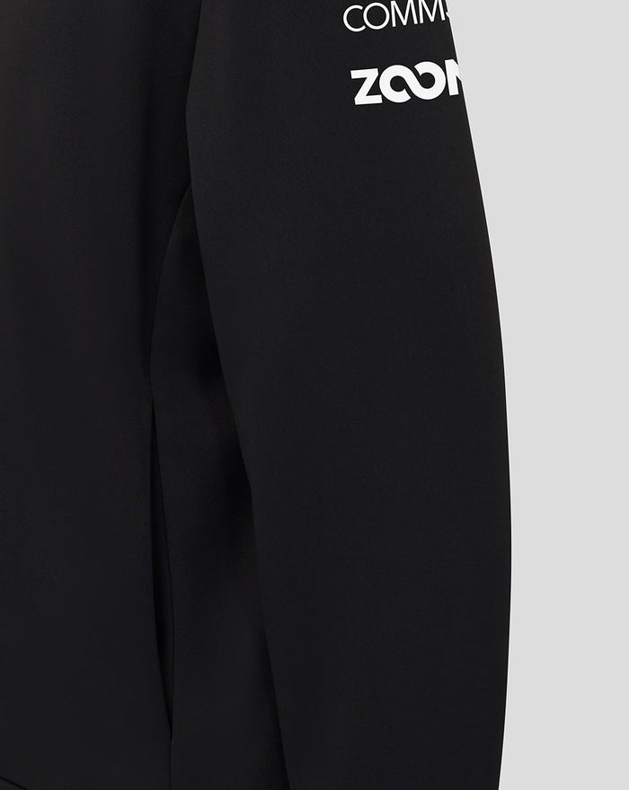 Close-up of black Haas Team Junior Pullover Hoodie showing contrast shoulder panel and white branding on the sleeve