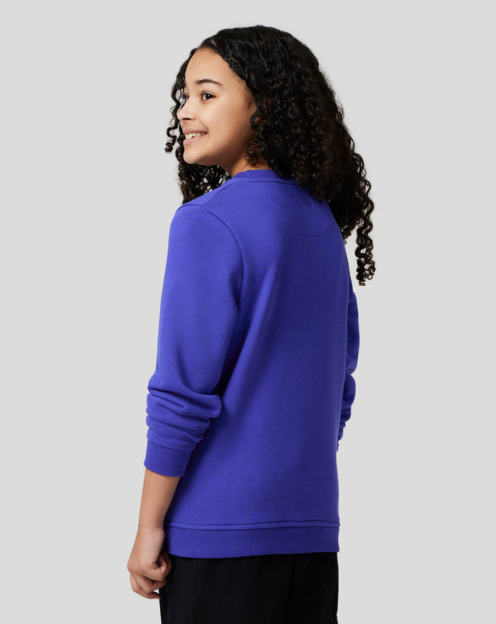 Side profile of a young model wearing royal blue Junior Silverstone Core Sweatshirt