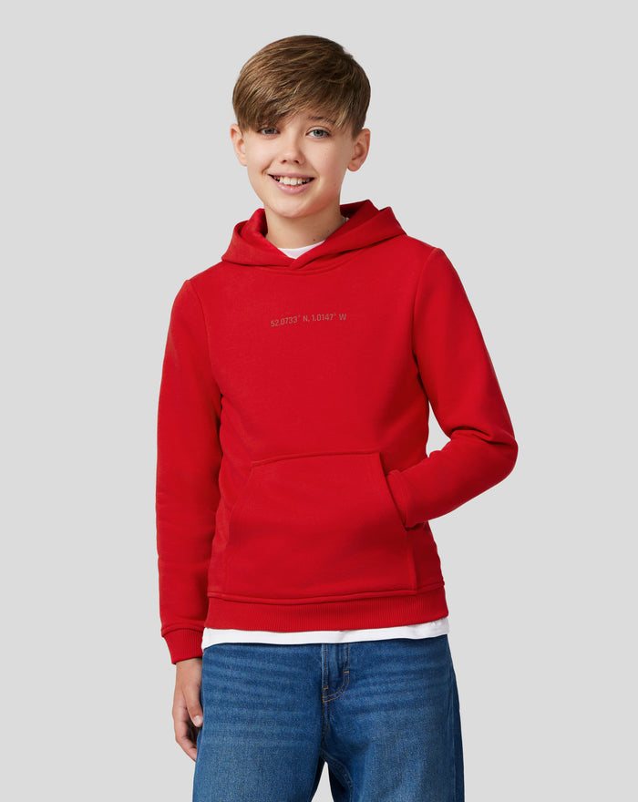 Young model wearing racing red Junior Silverstone Core Hoodie with chest graphic and front kangaroo pocket