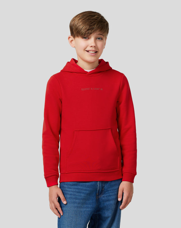 Front view of a child wearing a red Junior Silverstone Core Hoodie with a kangaroo pocket.