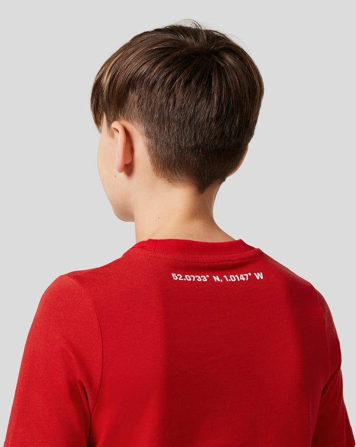 Back view of junior in Racing Red Silverstone Core T-Shirt showing coordinates printed on the lower back