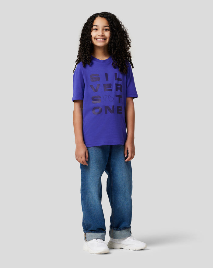 Girl wearing a royal blue Junior Silverstone Core Graphic T Shirt with the SILVER graphic and jeans