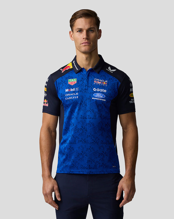 Male model wearing Oracle Red Bull Racing Teamline polo in night sky blue with bold branding on chest and sleeves
