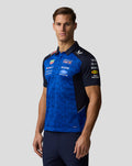 Male model wearing Oracle Red Bull Racing Teamline Polo in Night Sky Surf The Web with blue patterned torso and navy sleeves