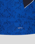Close-up of blue AerTek polo fabric showing a pixelated pattern and the AerTek label