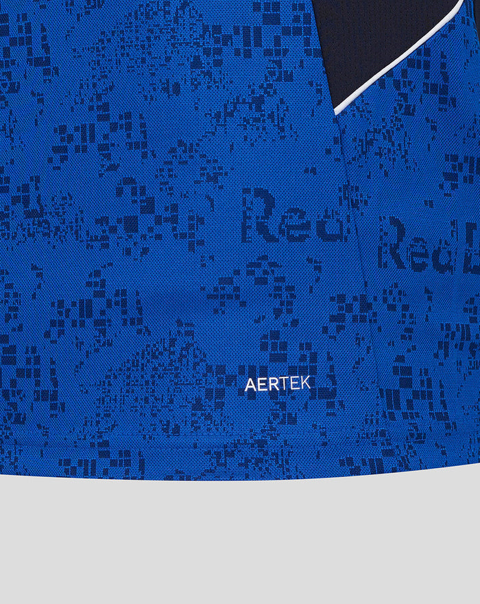 Close-up of blue AerTek polo fabric showing a pixelated pattern and the AerTek label