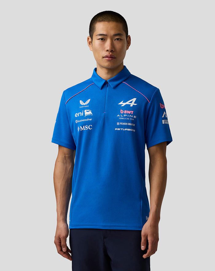 Male model wearing blue Official Men's BWT Alpine Formula One Team Polo Shirt with front logos and pink piping.
